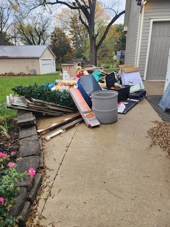 Dumpster being loaded with debris for Estate Cleanout Dumpster Rental in Chattanooga